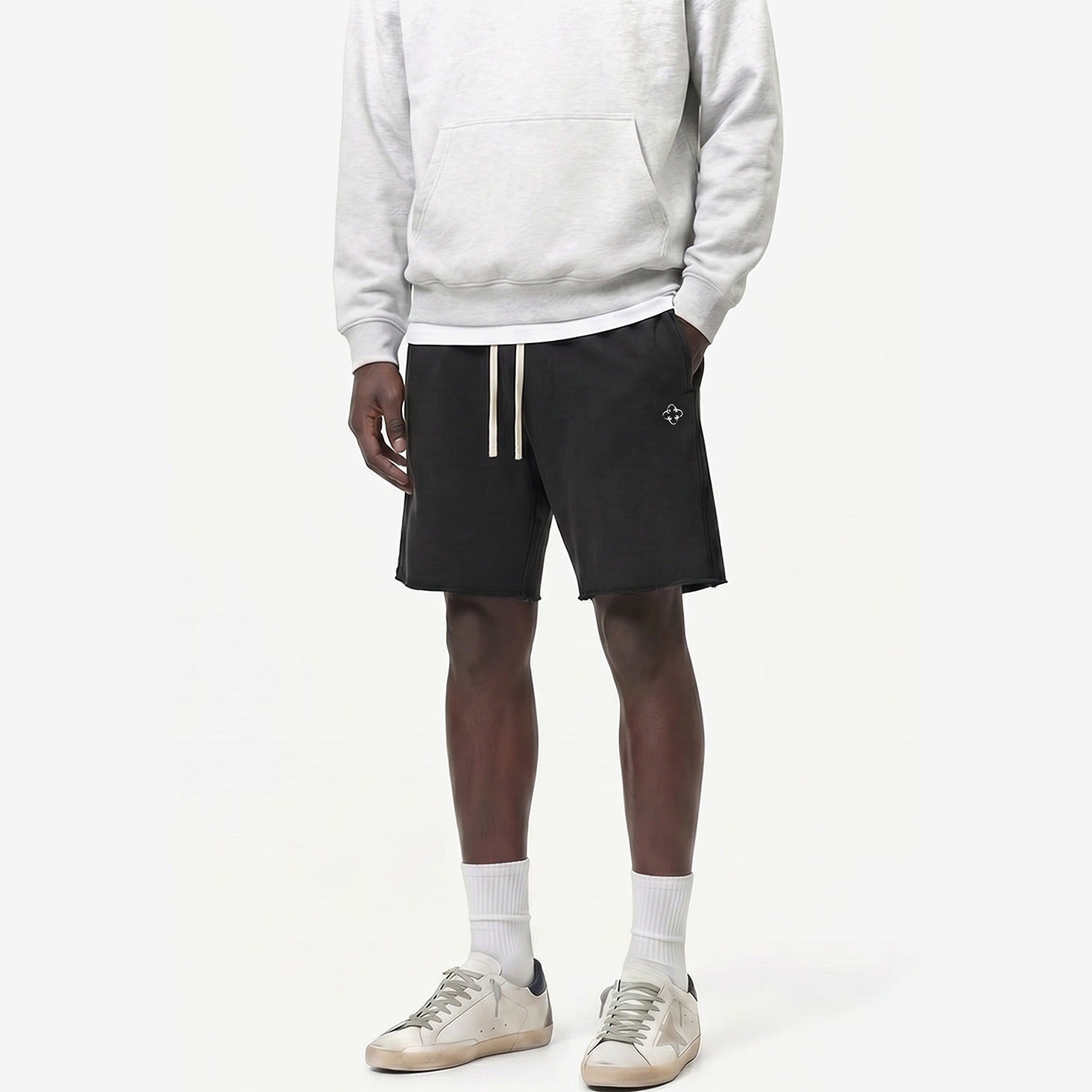 Raw Edge Emblem Shorts in Charcoal Black – worn by model