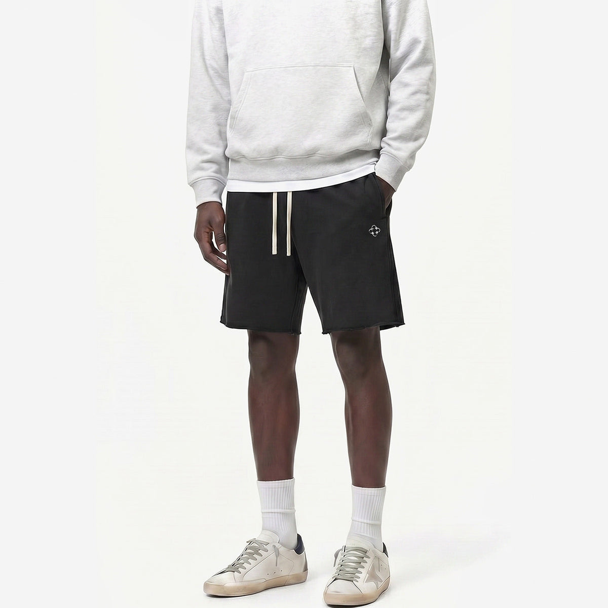 Raw Edge Emblem Shorts in Charcoal Black – worn by model