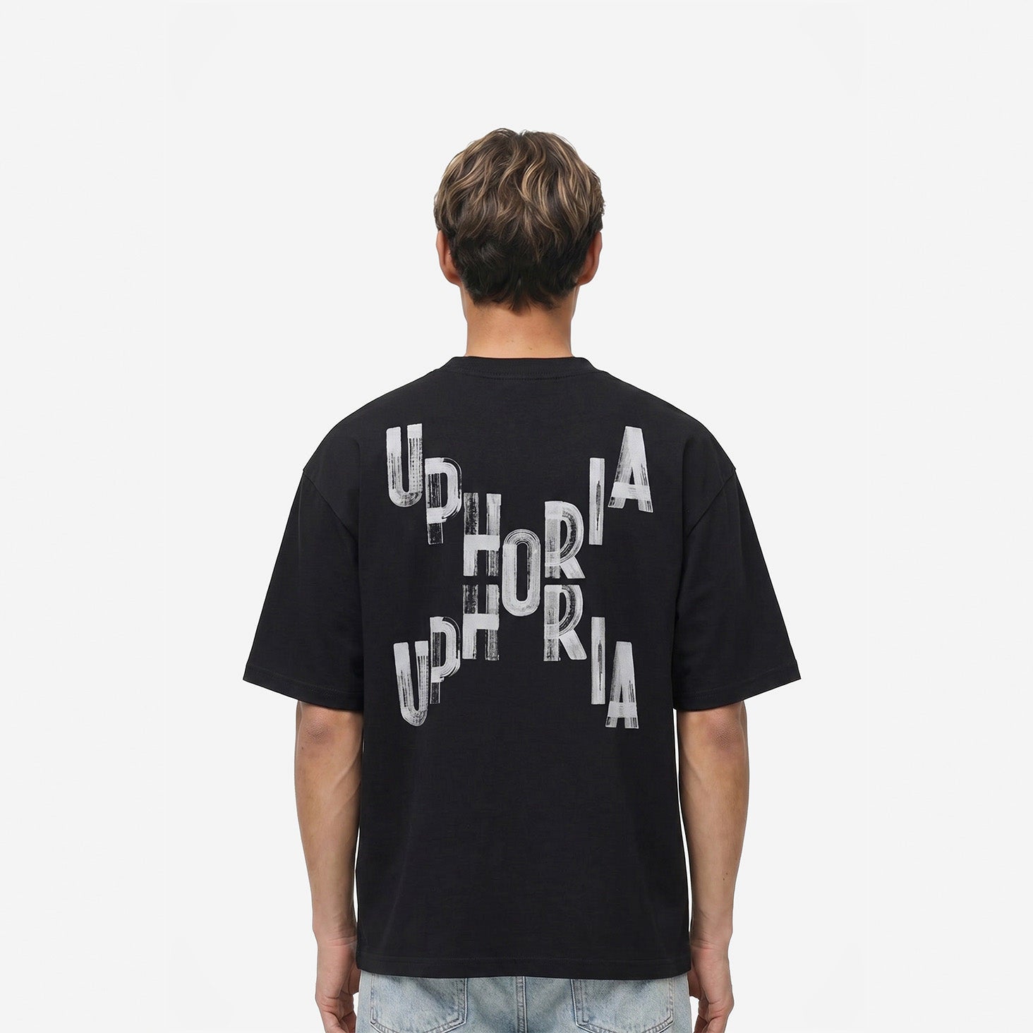 Signature Cross Tee in Black – worn by model, back view