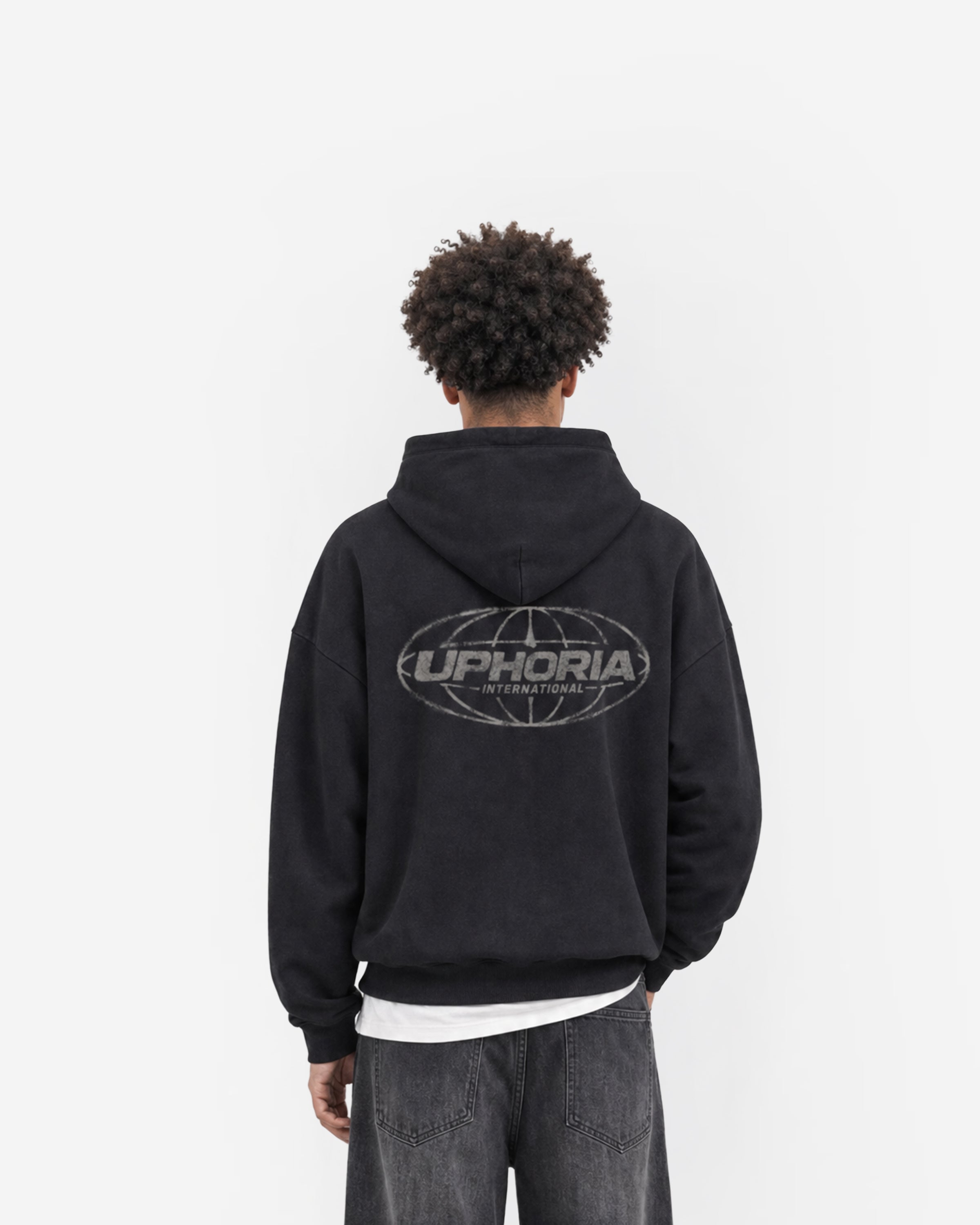 Globe Hoodie in Black – worn by model, back view