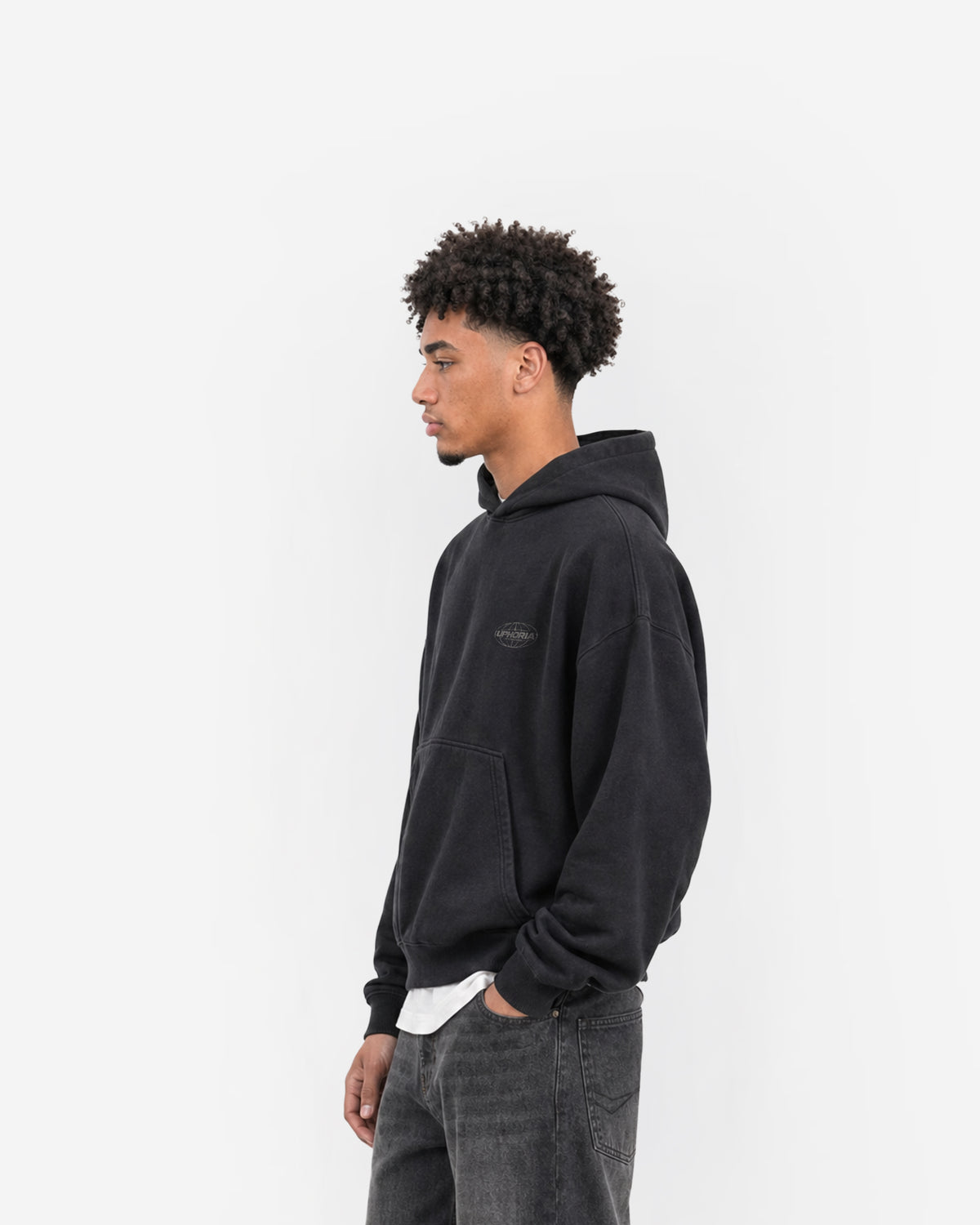 Globe Hoodie in Black – worn by model, side view