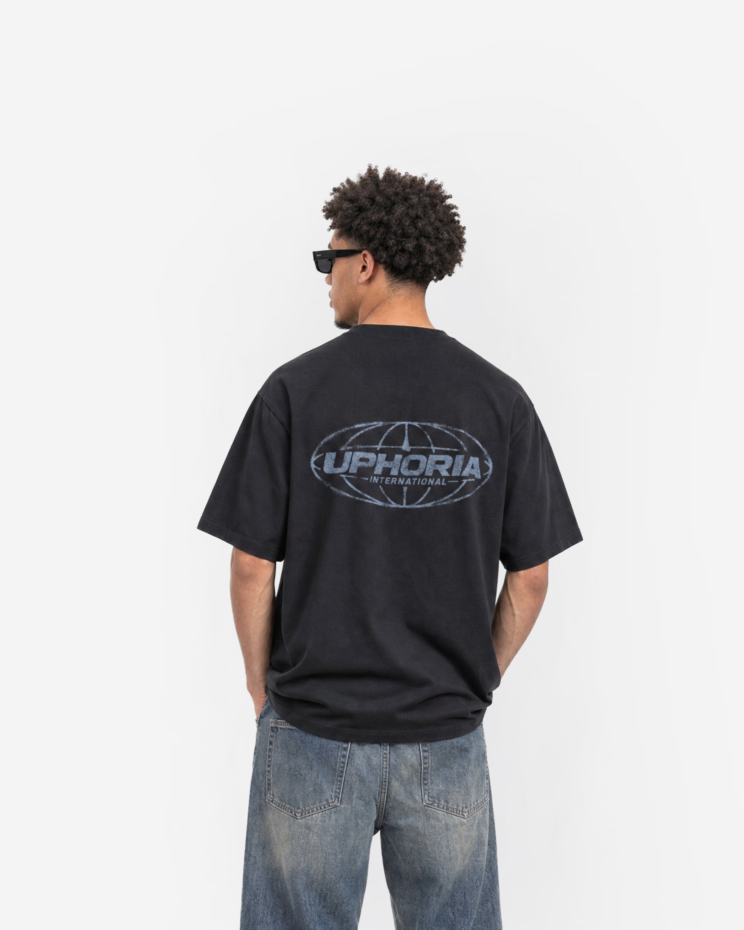Globe Tee in Black – worn by model, back view