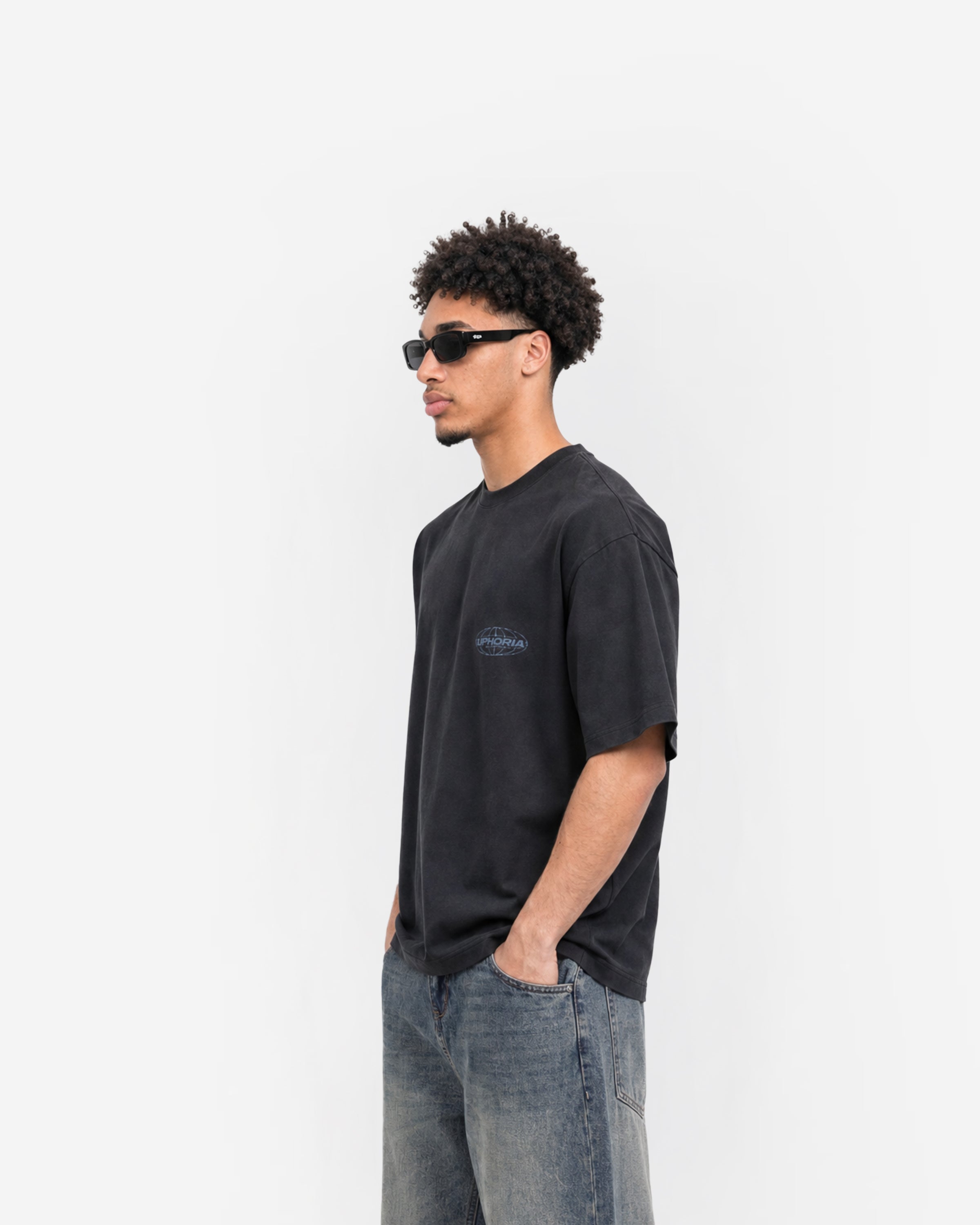 Globe Tee in Black – worn by model, side view