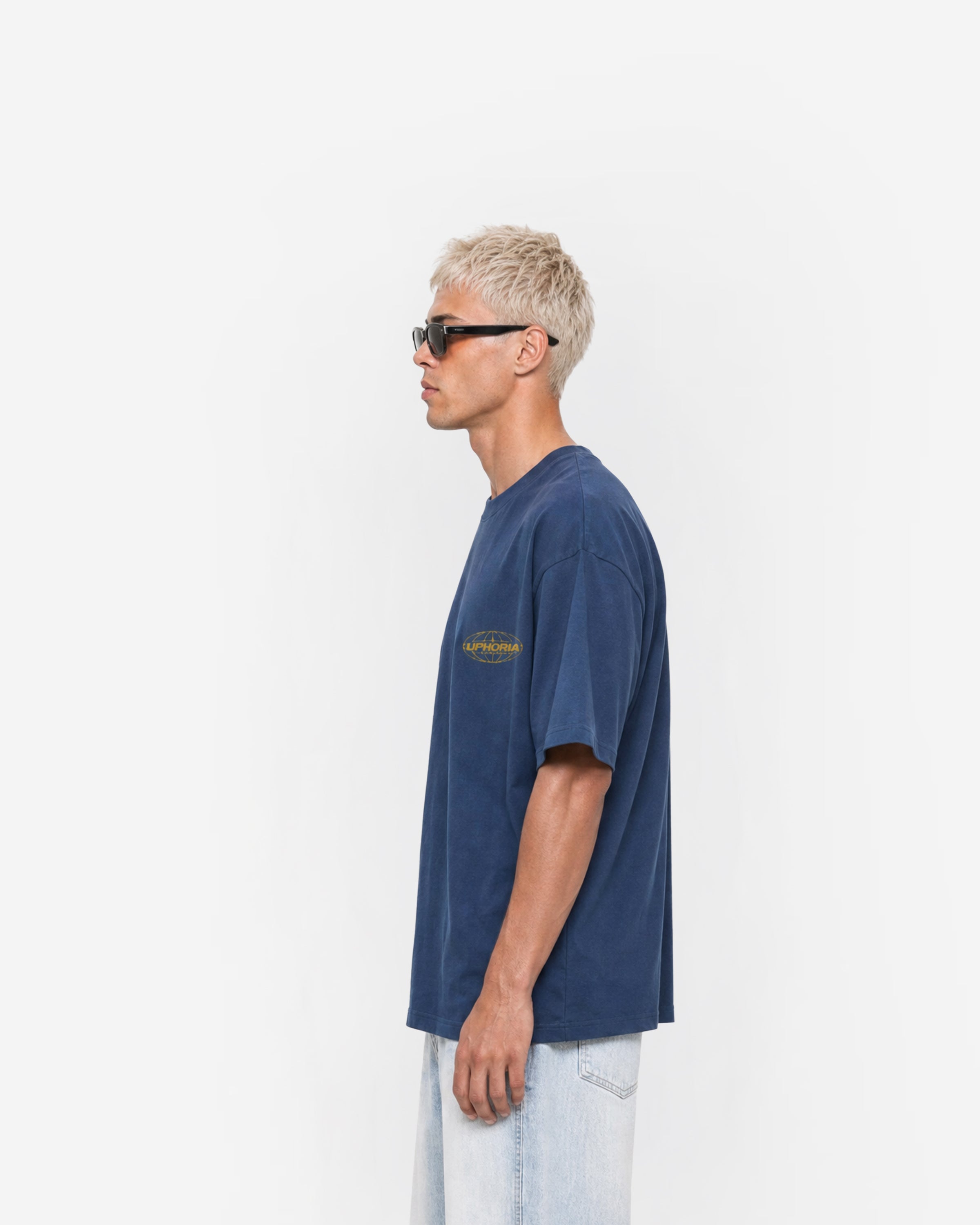 Globe Tee in Navy – worn by model, side view