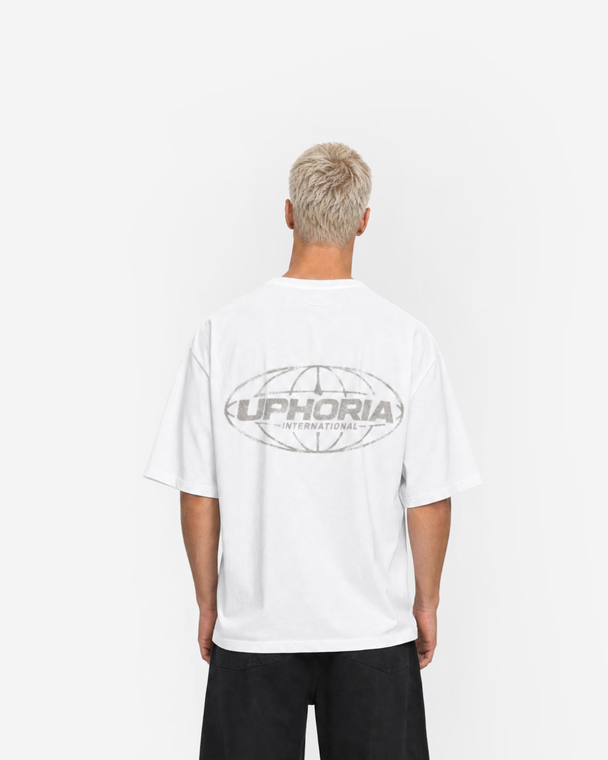 Globe Tee in White – worn by model, back view