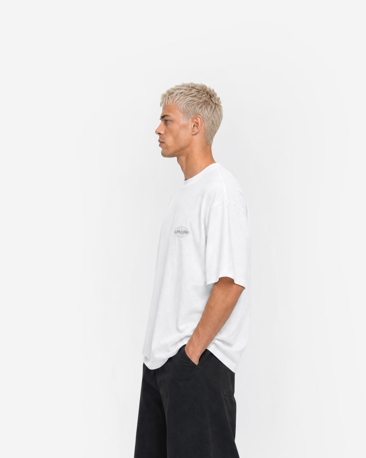 Globe Tee in White – worn by model, side view