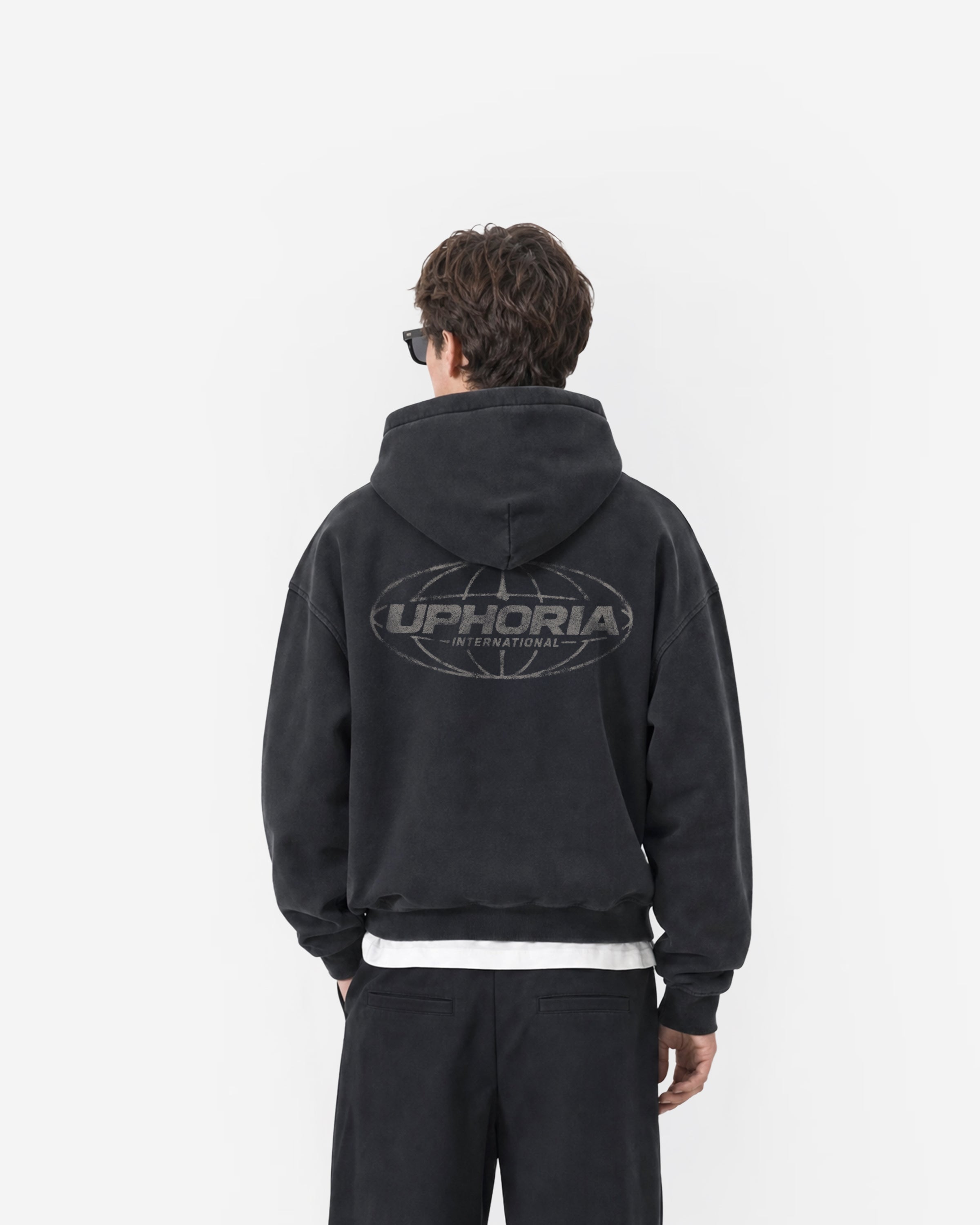 Globe Zip Hoodie in Black – worn by model, back view