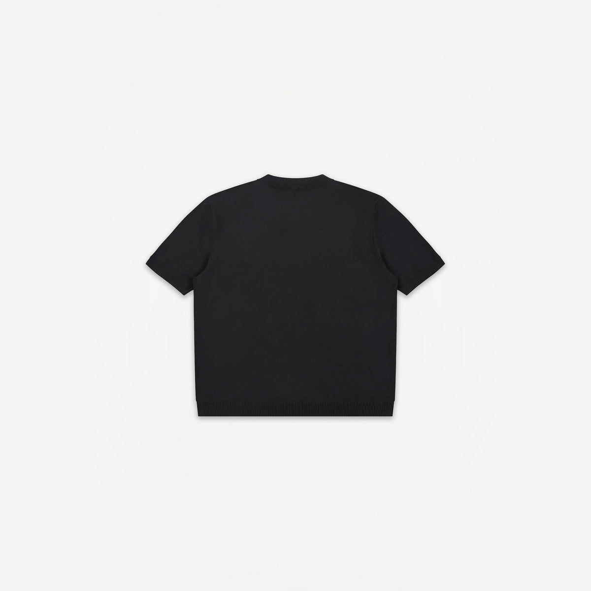 Como Henley Knit Tee in Black – flat lay, back view